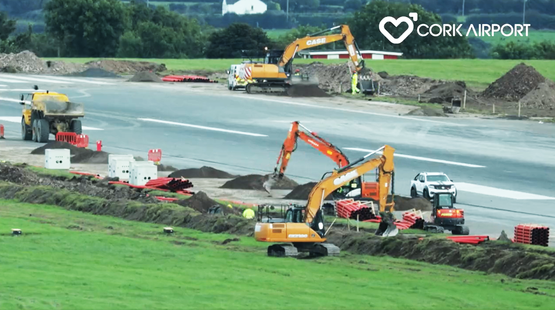 diggers installing pipework at the side of the runway at cork airport in ireland